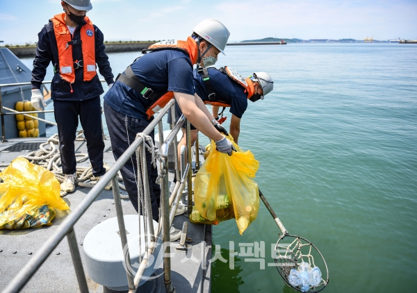 5월 28일 목요일, 해안 환경정화활동에 참여한 2함대 항만지원대 장병들이 군항 인근 해안가에서 쓰레기 수거작업을 하고 있다. [사진=해군2함대]